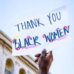 Person holding sign that says "Thank you Black Women"